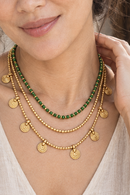 AI-styled waist-up photograph of Tiffany wearing the jewelry in a sunlit courtyard