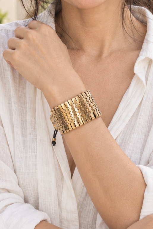 AI-styled waist-up photograph of Tiffany wearing the jewelry in a sunlit courtyard
