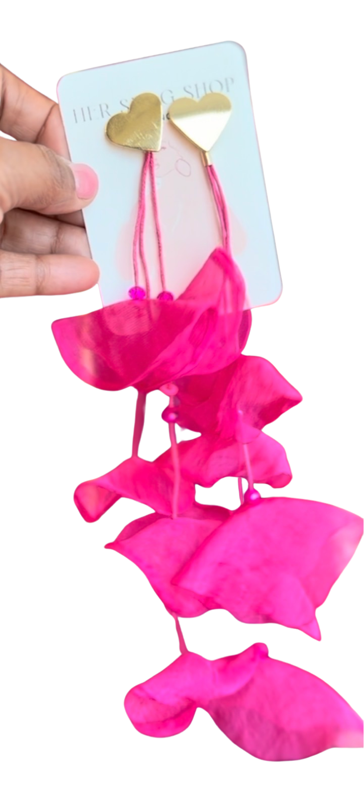 Hand holding hot pink chiffon HER SIGNATURE BLOOM earrings on a pale blue HER SWAG SHOP card.