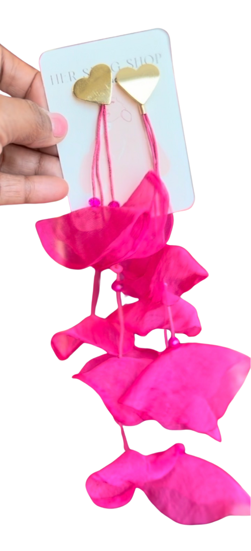 Hand holding hot pink chiffon HER SIGNATURE BLOOM earrings on a pale blue HER SWAG SHOP card.